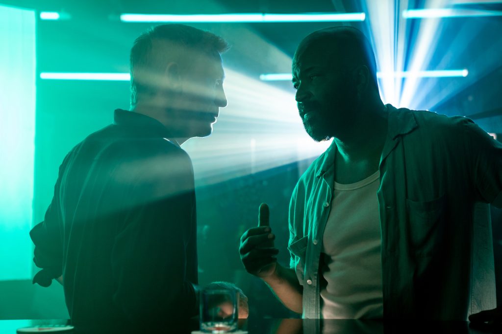James Bond (Daniel Craig) talks to Felix Leiter (Jeffrey Wright) in a nightclub in Jamaica in  NO TIME TO DIE