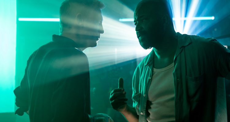 James Bond (Daniel Craig) talks to Felix Leiter (Jeffrey Wright) in a nightclub in Jamaica in NO TIME TO DIE