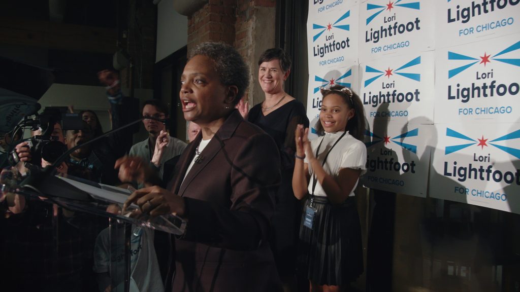 Lori Lightfoot delivers her victory speech with her family in the background after winning the Chicago Mayor's race in 2019 in Steve James' CITY SO REAL.